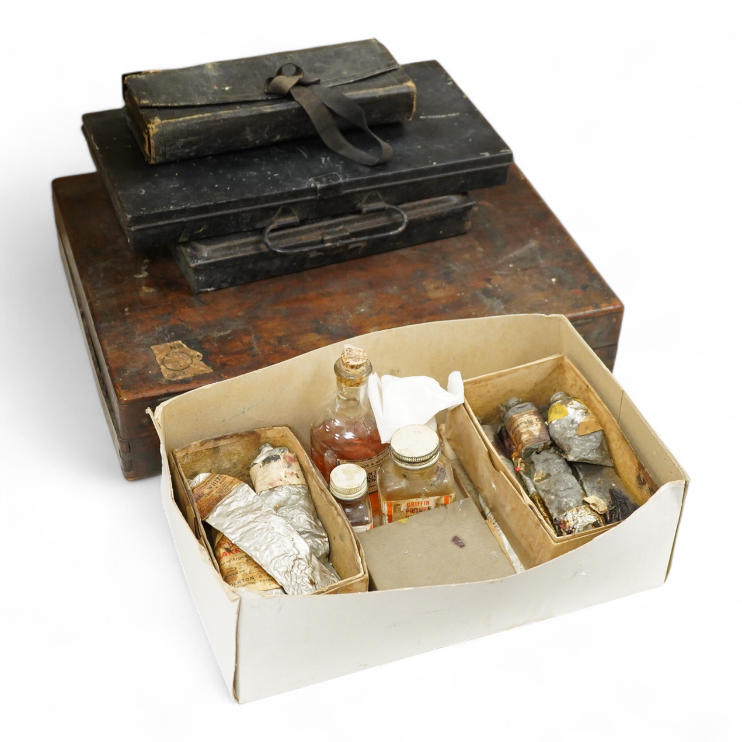 Three early to mid 20th century artist’s paint boxes, one tin box with Winsor and Newton label to the inside of the lid, plus a Rowley labelled box, a wooden paint box- 39cm wide, together with a leather pencil case, the